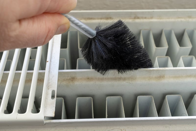 an image of a radiator brush being used to clean radiator